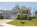 Inviting two-story home featuring a lush lawn, three-car garage and stone accents at 4333 Ironclad Dr, Bargersville, IN 46106