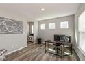 Well-lit home office with wood floors, neutral walls, and modern decor at 4333 Ironclad Dr, Bargersville, IN 46106