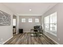 Bright office space featuring wood floors, three windows, and a modern workstation at 4333 Ironclad Dr, Bargersville, IN 46106