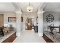 Elegant foyer featuring tile floors, decorative columns, and an open view into the adjoining living spaces at 4411 Westminster Pl, Columbus, IN 47201