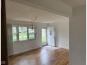Bright living room showcasing hardwood floors and a large window offering ample natural light at 5209 S Bancroft St, Indianapolis, IN 46237