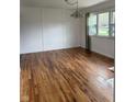 Spacious living room featuring wood floors and modern lighting fixtures at 5209 S Bancroft St, Indianapolis, IN 46237