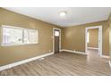 A cozy living room featuring hardwood floors and a large window that brings in natural light at 525 S Keystone Ave, Indianapolis, IN 46203