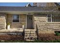 Home featuring stone exterior, flowers, and a beautiful entry way at 5802 Crittenden Ave, Indianapolis, IN 46220