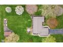 Aerial view of a well-maintained home featuring a large yard and patio at 5925 Leisure Ln, Pittsboro, IN 46167
