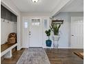 Bright foyer features wood floors, storage bench, and stylish decor at 5925 Leisure Ln, Pittsboro, IN 46167