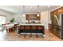 Spacious kitchen island with seating complements stainless steel appliances, and sleek countertops at 605 Tuscany Trl, Lapel, IN 46051