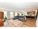 Open concept living room boasts hardwood floors, natural light, and comfortable seating area at 605 Tuscany Trl, Lapel, IN 46051