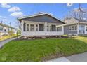 Delightful home with a spacious covered porch, offering a perfect spot for relaxation and enjoying the outdoors at 67 S 9Th Ave, Beech Grove, IN 46107