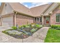 Close-up of a charming brick home's front exterior and landscaped entry at 7113 Lakeside Woods Dr, Indianapolis, IN 46278