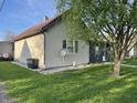 View of home's side exterior showcasing the well-kept lawn and tidy space at 760 E Walnut St, Martinsville, IN 46151