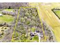 Aerial view of land showing home and surrounding property with a perimeter outlined in yellow showing lot lines at 8327 S County Road 825 E, Plainfield, IN 46168