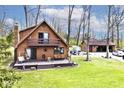 A-frame house boasts a large deck and balcony, complemented by a detached garage and lush green lawn at 8327 S County Road 825 E, Plainfield, IN 46168