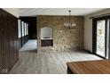 Dining Room with stone accent wall, tile flooring and stylish chandelier at 8801 Ridge Hill Dr, Indianapolis, IN 46217