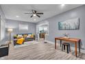 Cozy living room featuring modern paint, a ceiling fan and a comfortable sofa at 936 N Oxford St, Indianapolis, IN 46201