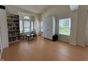 Inviting living room featuring a bookcase, sitting area, and bright windows at 10404 Trillium Ct, Noblesville, IN 46060