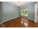 Bright living room featuring hardwood floors, large windows, and neutral wall color at 11648 Stickney Ct, Fishers, IN 46037