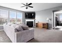 Spacious living room with a fireplace, plush sofa, and lots of natural light creates a cozy and inviting atmosphere at 1243 Colinbrook Cir, Greenwood, IN 46143