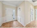 Bright foyer with tiled floor, white trim and panelling, and a white front door at 12907 Shiraz Ln, Fishers, IN 46037