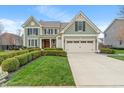 Beautiful two-story home featuring a well-maintained lawn, a two-car garage, and classic design elements at 14910 Declaration Dr, Westfield, IN 46074
