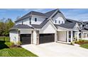 Beautiful two-story home with a three-car garage, attractive stonework, and well-maintained landscaping at 15341 Montfort Dr, Noblesville, IN 46062