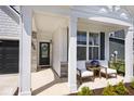 Inviting front porch with comfortable seating and stylish accents at 15341 Montfort Dr, Noblesville, IN 46062