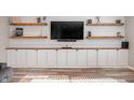 Stylish built-ins and shelves adorn the living room, complemented by sleek cabinets at 15762 Hargray Dr, Noblesville, IN 46062