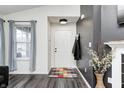 Stylish home foyer with white door, modern decor, and wood-look floors offers a welcoming entrance at 1614 Ashley Dr, Lebanon, IN 46052