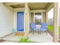 Inviting front porch with blue door, cozy seating, and charming details creates a welcoming entrance at 1614 Ashley Dr, Lebanon, IN 46052