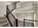 Bright foyer with hardwood floors, a staircase with dark wood railing and a view to the entry at 17269 Dallington St, Westfield, IN 46074