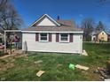 Rear view of home with white siding and red shutters at 1901 S F St, Elwood, IN 46036