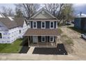 Aerial view of a gray two-story home featuring a welcoming front porch and neatly landscaped front yard at 1921 Union St, Indianapolis, IN 46225