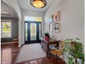 Well-lit foyer featuring stylish art and a beautiful front door with decorative glass at 1995 Brookfield Ct, Columbus, IN 47201
