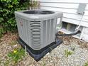 Exterior shot of the home's newer HVAC system, placed on a stone pad near the foundation at 212 W Burnside Ave, Fairland, IN 46126