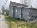 Side view of the house showing exterior finishes and gas and electric meters at 214 S 10Th St, Elwood, IN 46036
