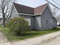 Side view of the house showing the quaint architecture and the exterior finishes at 214 S 10Th St, Elwood, IN 46036