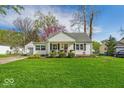 Attractive home with a lush green lawn, tidy landscaping, and traditional architectural details at 2204 Pamela Dr, Indianapolis, IN 46220