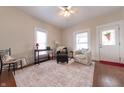 Cozy living room featuring hardwood floors, neutral walls, ceiling fan, and natural light from two bright windows at 282 N Mapleton St, Columbus, IN 47201