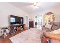 Comfortable living room featuring a decorative fireplace, media center, hardwood floors, and a cozy sofa at 282 N Mapleton St, Columbus, IN 47201