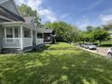 The side yard showcases the home's well-maintained landscaping and curb appeal in a serene neighborhood setting at 3031 Nowland Ave, Indianapolis, IN 46201
