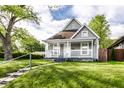 This lovely home offers a quaint front porch and lush landscaping, creating a welcoming curb appeal at 3031 Nowland Ave, Indianapolis, IN 46201