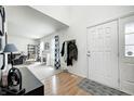 Bright foyer featuring a white door with glass insert and an open view of the living area at 3051 Firestone Cir, Indianapolis, IN 46234
