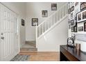 Inviting foyer with hardwood flooring, a staircase with white railing, and space for decor at 3051 Firestone Cir, Indianapolis, IN 46234