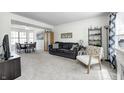 Comfortable living room adjacent to dining area, featuring neutral carpet and modern decor at 3051 Firestone Cir, Indianapolis, IN 46234