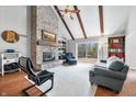 Inviting living room features a brick fireplace, vaulted ceilings, exposed beams, and sliding doors to the deck at 3331 Daniel St, Mooresville, IN 46158