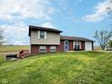 Charming home featuring a well-manicured lawn, attached garage, and inviting front entrance at 3703 E Gore St, Columbus, IN 47201