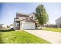 Charming two-story home with a well-manicured lawn and long driveway at 3896 Woods Bay Ln, Plainfield, IN 46168
