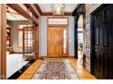 Inviting foyer features wood flooring, an elegant light fixture, and a front door with sidelights at 4052 Diamond Row, Greenwood, IN 46143