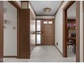 Interior hallway featuring neutral carpet and trim and a view into a dining room at 426 Oakwood Dr, Indianapolis, IN 46260