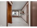 Bright living room featuring neutral walls, wall sconces, large window, and doorway access to other rooms at 426 Oakwood Dr, Indianapolis, IN 46260